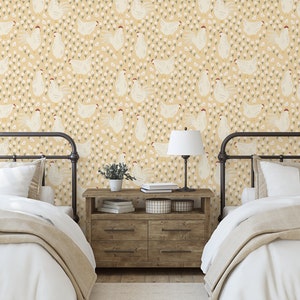 May include: Two twin beds with white bedding and a yellow and white chicken print wallpaper. A wooden nightstand with a lamp and a potted plant sits between the beds.