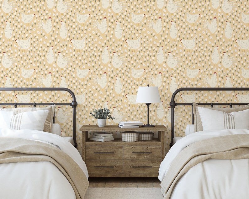 May include: Two twin beds with white bedding and a yellow and white chicken print wallpaper. A wooden nightstand with a lamp and a potted plant sits between the beds.