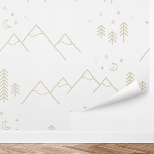 May include: A white wallpaper with a repeating pattern of mountains, trees, stars, and a crescent moon. The pattern is in a light brown color.