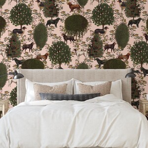 May include: A bedroom with a pink wallpaper featuring a repeating pattern of stylized trees, flowers, and dogs. The wallpaper is behind a white bed with a beige headboard and white bedding.