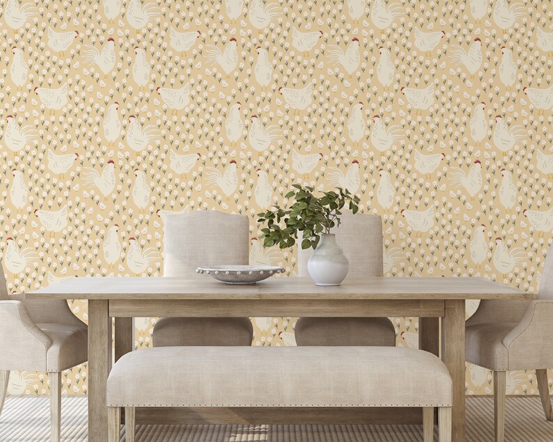 May include: A dining room with a light yellow wallpaper featuring a repeating pattern of white chickens and small white flowers. The wallpaper is on the wall behind a wooden table with two chairs and a bench.