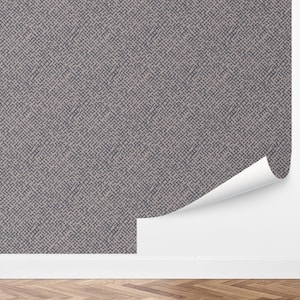 May include: A section of wallpaper with a repeating geometric pattern in shades of gray and beige. The wallpaper is partially peeled back, revealing a white wall. The bottom of the image shows a wooden floor.