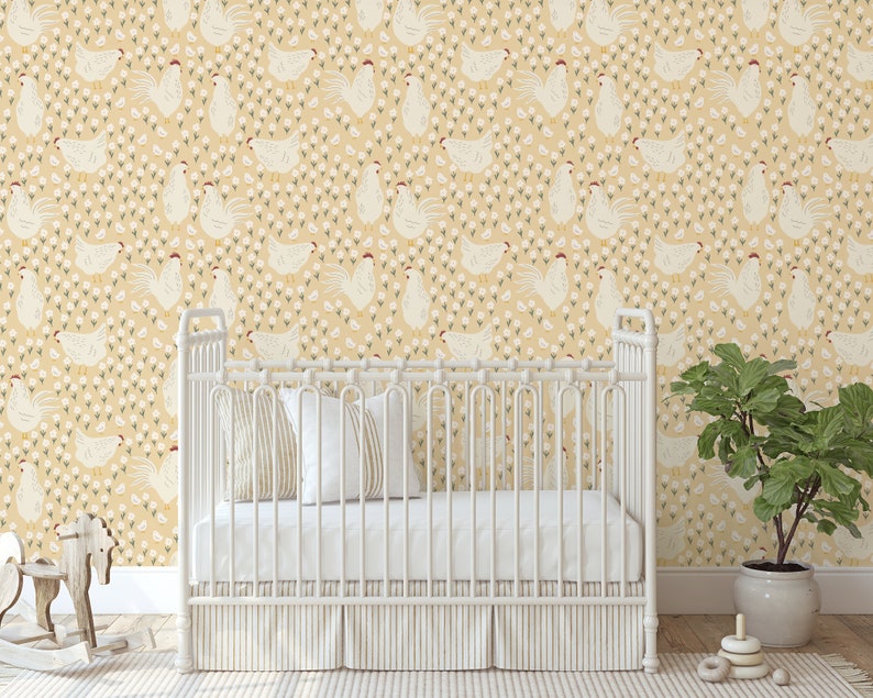 May include: A white crib with a yellow and white chicken patterned wallpaper. The crib has a white mattress and a white blanket. There is a rocking horse in the foreground and a potted plant in the background.