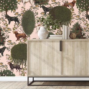 May include: A pink wallpaper with a repeating pattern of dogs, trees, and flowers. A wooden cabinet with two doors is in front of the wallpaper.