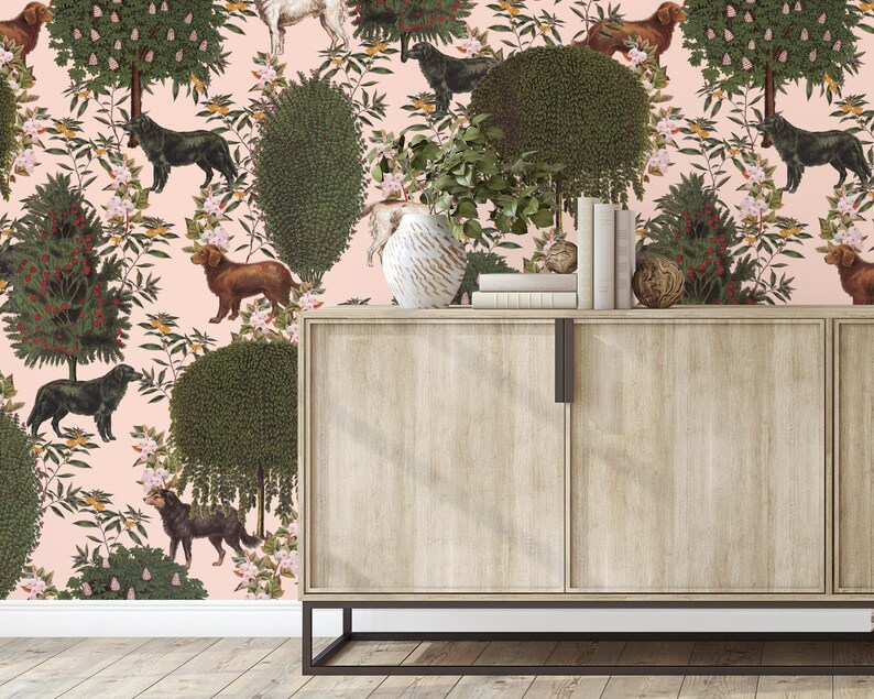 May include: A pink wallpaper with a repeating pattern of dogs, trees, and flowers. A wooden cabinet with two doors is in front of the wallpaper.