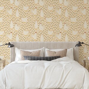 May include: A white bed with a white duvet cover and two pillows. The headboard is beige and the wall behind it is covered in a yellow wallpaper with a repeating pattern of white chickens and small white flowers.