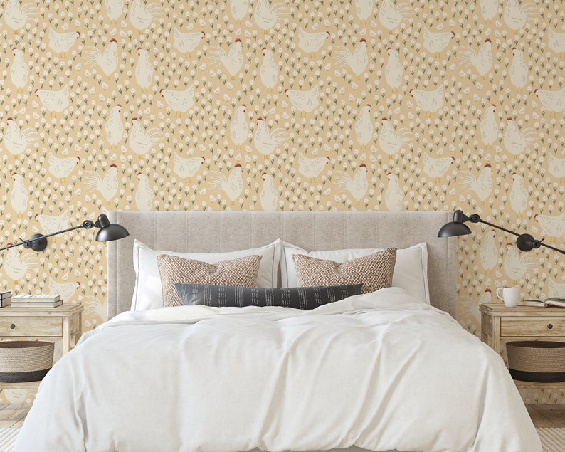 May include: A white bed with a white duvet cover and two pillows. The headboard is beige and the wall behind it is covered in a yellow wallpaper with a repeating pattern of white chickens and small white flowers.