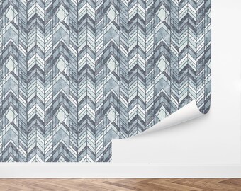 May include: A blue and white chevron patterned wallpaper with a subtle watercolor effect. The wallpaper is shown partially rolled up, revealing the pattern.