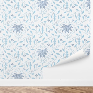 May include: A white wallpaper with a repeating pattern of blue floral designs. The pattern features stylized flowers and leaves.