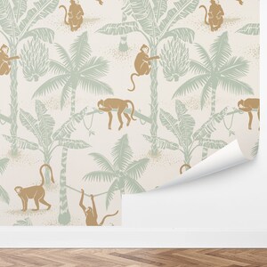 May include: A seamless pattern featuring monkeys swinging from palm trees on a light beige background. The monkeys are brown and the palm trees are green.