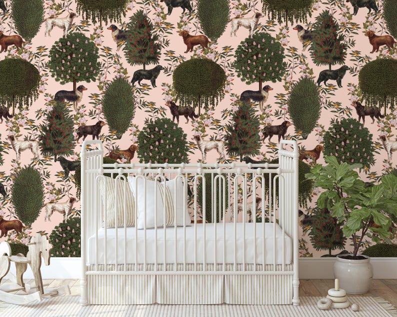 May include: A white crib with a white mattress and a white sheet. The crib is in front of a pink wall with a repeating pattern of green trees and brown dogs.