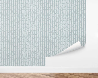 May include: A light blue wallpaper with a repeating pattern of white, vertical, geometric shapes. The pattern resembles a woven fabric.