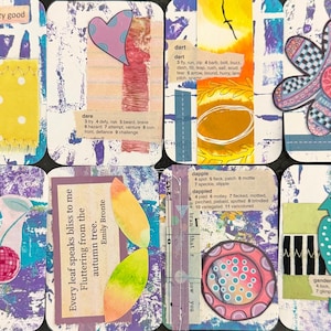 May include: Eight rectangular mixed-media art cards featuring collage elements, including fabric scraps, dictionary definitions, hand-drawn flowers, a bird, a disco ball cherry, and inspirational text like crazy good and life is a dance.