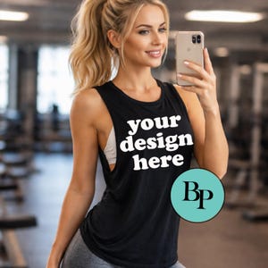 May include: Black sleeveless workout tank top with the text "your design here" in white. The tank top has a scoop neck and a racerback design. A teal circle with the letters "Bp" is on the bottom right.