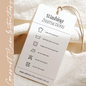 a white laundry instructions tag with black text and icons, providing guidelines for washing clothes.