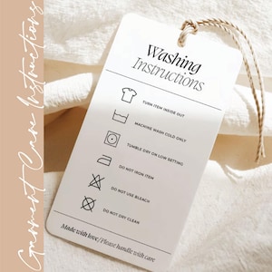 a white laundry instructions tag with black text and icons, providing guidelines for washing clothes.