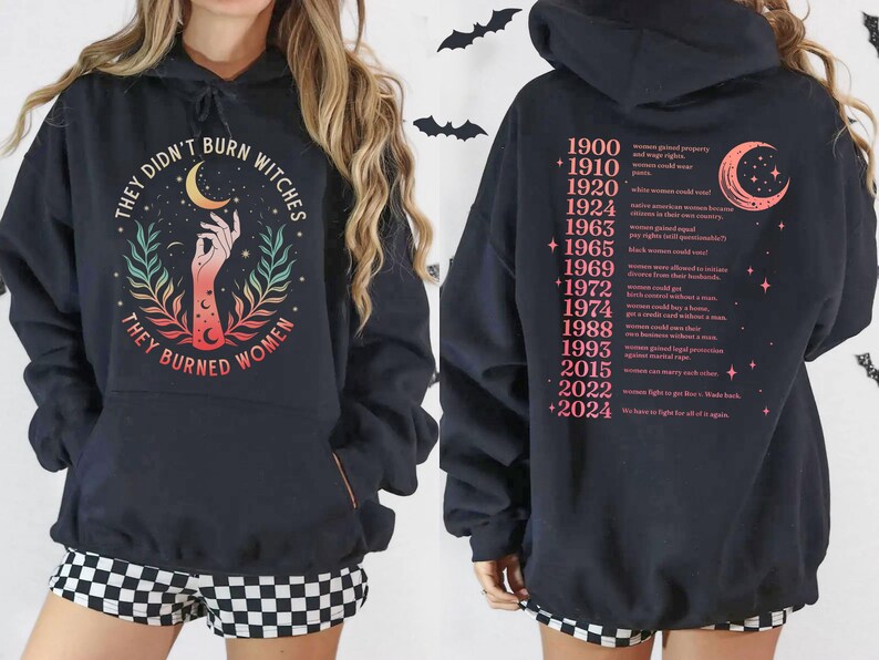 a black hoodie with a graphic design and text on the back.