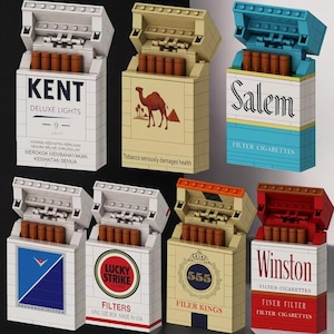 May include: A collection of toy cigarette boxes in various colors and designs. The boxes are labeled with brands like "Kent," "Camel," "Salem," "Lucky Strike," "555," and "Winston." Each box is open, revealing the toy cigarettes inside. The text "Tobacco seriously damages health" is visible.