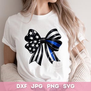 May include: White t-shirt featuring a large bow design. The bow has a black and white striped pattern, a section with white stars on a black background, and a blue stripe. The bottom of the shirt has the text "DXF JPG PNG SVG".