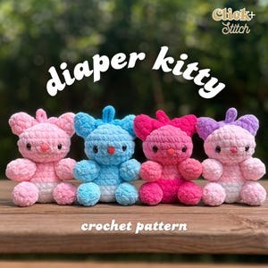 May include: Four colorful crochet diaper kitties in pink, blue, and purple sit on a wooden surface. The text "diaper kitty" is above the toys, and "crochet pattern" is below. The toys have button eyes and small bows.