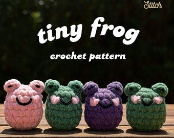 May include: Four crocheted tiny frog toys in pink, green, and purple, each with a smiling face and heart-shaped accents. The text "tiny frog crochet pattern" is displayed in white. The Click + Stitch logo is in the upper right corner.