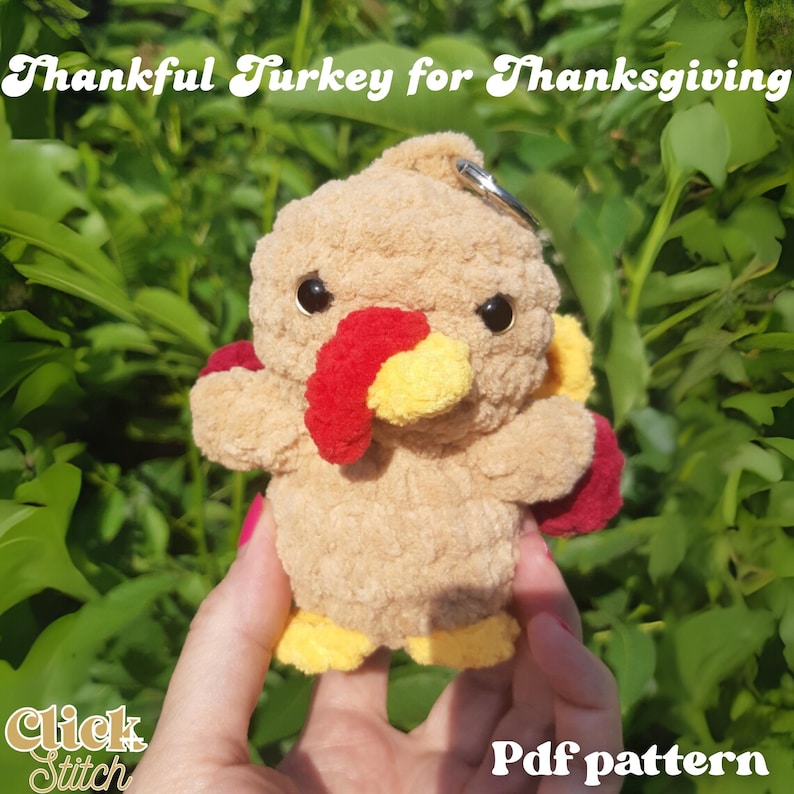 May include: A plush, tan-colored turkey keychain with red, yellow, and black accents. The turkey has a red wattle and yellow feet. The text "Thankful Turkey for Thanksgiving" is above the turkey, and "Pdf pattern" is below.