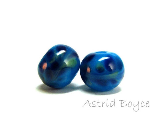 Violet Splash - artisan lampwork beads -Free USA Shipping -Various shades of violet glass and green glass swirled over opal turquoise glass