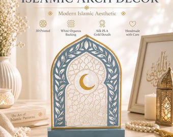 May include: An Islamic arch decor piece featuring a blue frame with leaf patterns, a gold crescent moon, and a white organza backing. The structure is mounted on a rectangular blue base, showcasing 3D printed construction and gold silk PLA details.