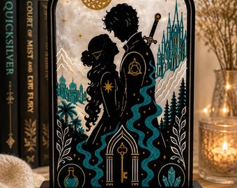 May include: An arched decorative display featuring a black silhouette of two figures facing each other, surrounded by teal and gold illustrations of a castle, moon, stars, and a key. The black base bears the text, Because she is moonlight.