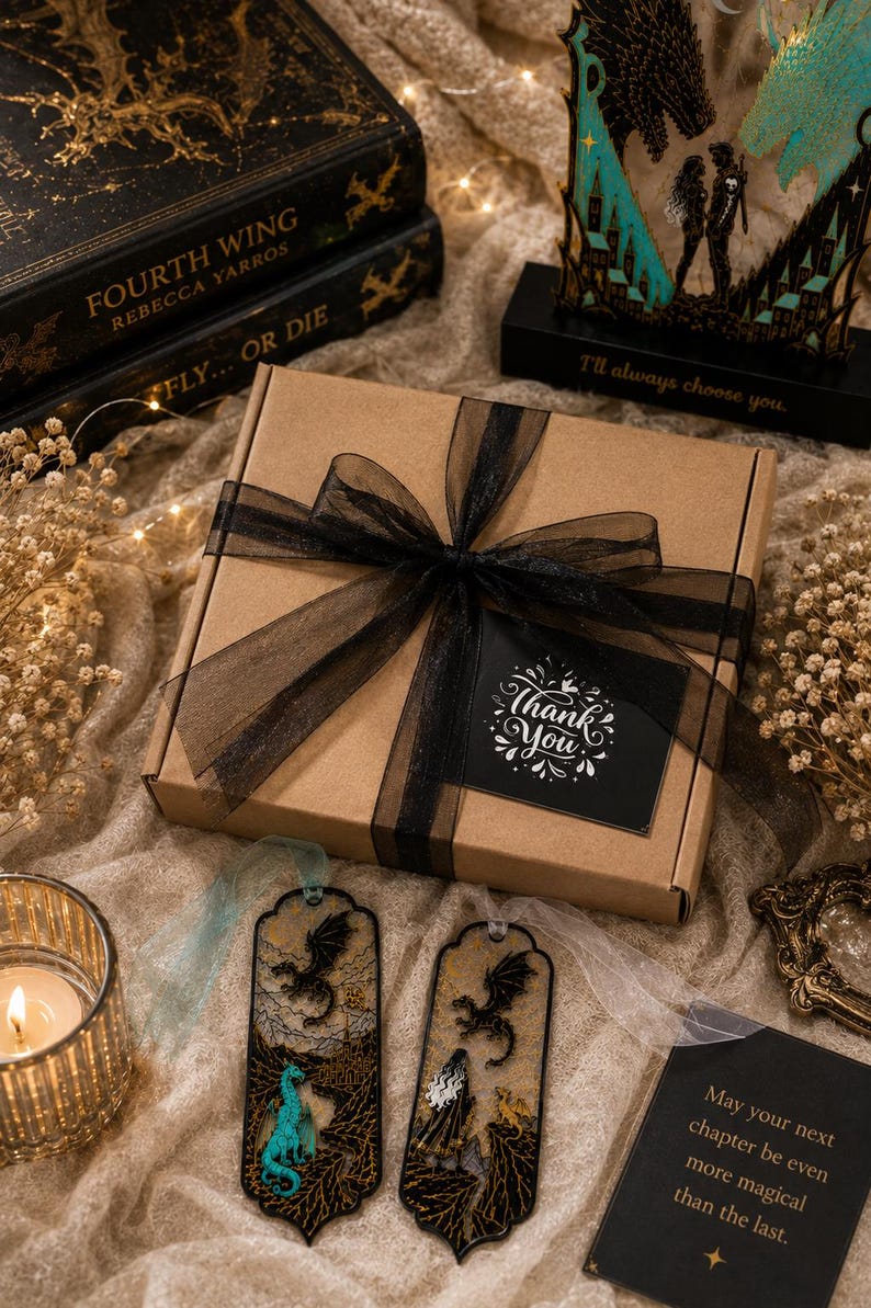 Two Fourth Wing inspired fantasy bookmarks with sheer organza backgrounds black gold turquoise and white 3D printed dragon designs.