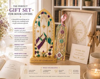 May include: A gold-colored arch stand with a mountain and star design, a coordinating bookmark with floral patterns and a pink ribbon, and a gift box. The stand base is labeled CITY OF STARLIGHT. The set includes a card reading A GIFT FOR YOU.