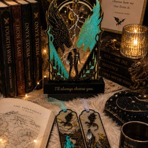 Fourth Wing gift set with blue and black dragon book stand and two matching fantasy bookmarks styled with books and warm bookish decor.