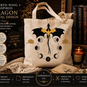 May include: A beige canvas tote bag featuring a central graphic of a black dragon with gold wings, surrounded by a circular arrangement of moon phases in black and gold. The design includes small gold cloud motifs on either side of the dragon.