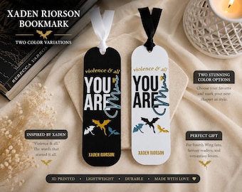 May include: Two rectangular bookmarks with rounded ends, one black and one white. Both feature the text "violence & all YOU ARE mine" and "XADEN RIORSON" with small dragon silhouettes. The black bookmark has a white ribbon, and the white bookmark has a black ribbon.