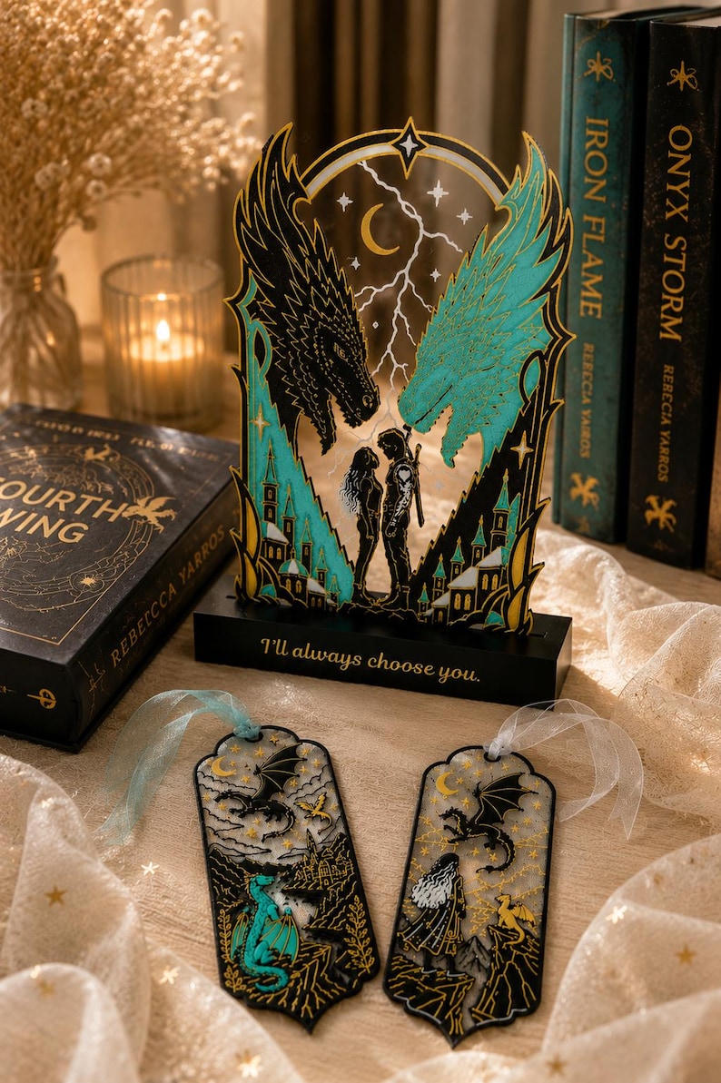 May include: A decorative acrylic stand featuring two dragon heads in black and teal facing each other above a couple, with the text "I'll always choose you." on the base. Two matching bookmarks with dragon and character illustrations are included.