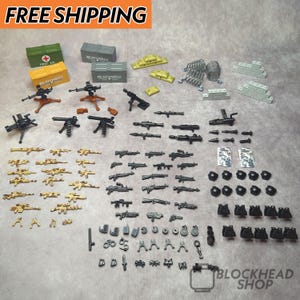 May include: A collection of miniature toy weapons and military accessories in various colors. Includes machine guns, rifles, grenades, ammo boxes, and first aid kits. The image has the text "FREE SHIPPING".