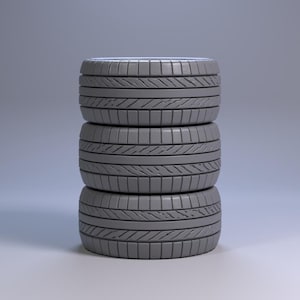 May include: Three grey car tyres stacked vertically. Each tyre features a tread pattern of horizontal and vertical grooves. The tyres are arranged one on top of the other, with the bottom tyre resting on a white surface. The background is a grey gradient.