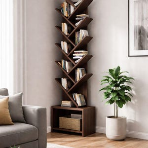 May include: A dark brown, tree-shaped bookcase filled with books of various sizes and colours. The bookcase is placed in a corner of a room, next to a grey sofa and a potted plant. A woven basket sits in the base of the bookcase.