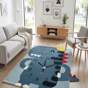 May include: A blue rug with a dinosaur clock design. The rug features a cartoon dinosaur with clock hands and numbers. The dinosaur has a yellow crown and red spikes. The rug is in a living room setting.