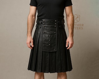Könnte beinhalten: Schwarzer Lederkilt mit plissiertem Design und Knopfdetails. Der Kilt hat einen breiten Gürtel mit Schnallen- und Knopfverschlüssen. Das Kleidungsstück ist knielang und hat ein traditionelles schottisches Design.