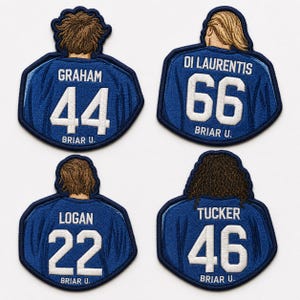 May include: Four embroidered patches in the shape of jerseys, in blue and white. Each patch displays a name and number: Graham 44, Di Laurentis 66, Logan 22, and Tucker 46. The text "BRIAR U." is at the bottom of each patch.