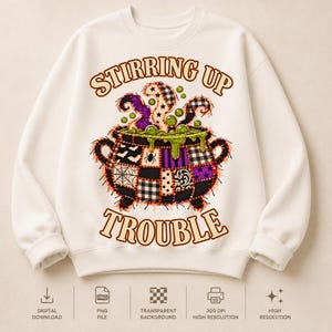 May include: A cream-colored crewneck sweatshirt featuring a graphic of a cauldron with a patchwork design in black, white, and purple. The cauldron contains green bubbling liquid and steam. The text reads STIRRING UP TROUBLE in orange letters.