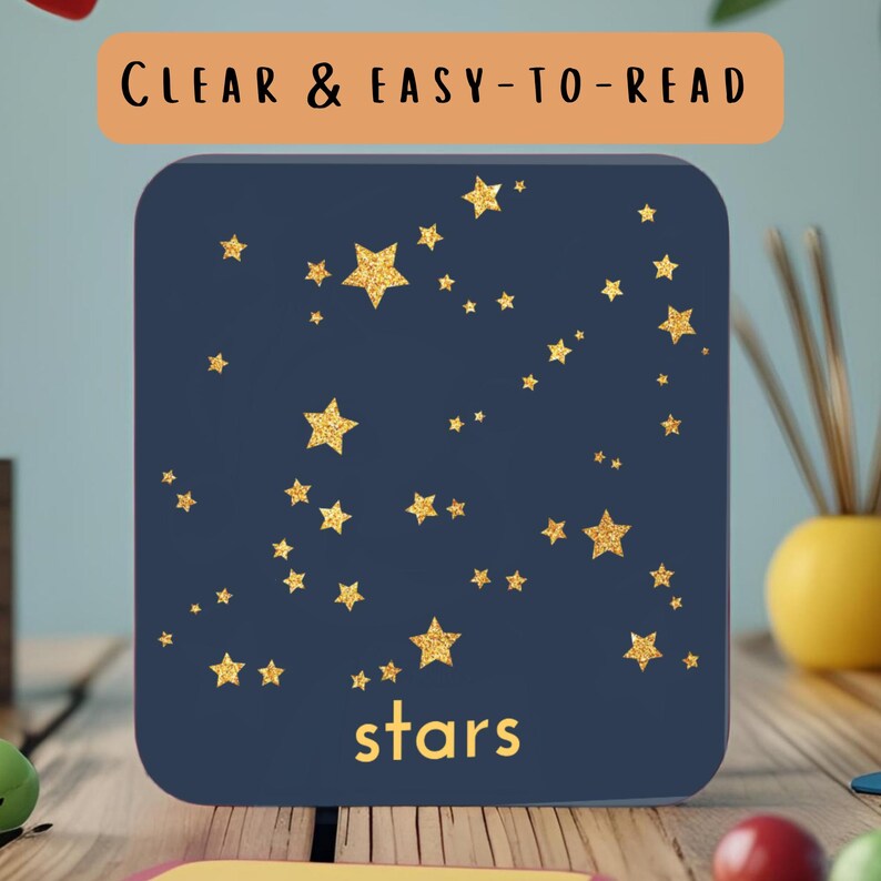 May include: A navy blue square with gold glitter stars of varying sizes. The word "stars" is in gold script at the bottom. The text "CLEAR & EASY-TO-READ" is in an orange rectangle at the top.