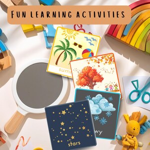 May include: Educational cards with illustrations of summer, fall, winter, and stars. The cards are surrounded by wooden toys, a magnifying glass, and a plush toy. The text "FUN LEARNING ACTIVITIES" is at the top.