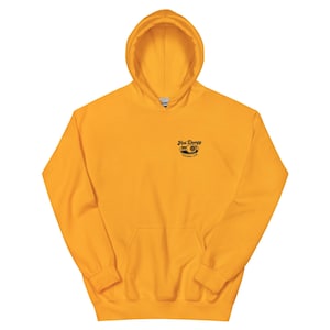 May include: Mustard yellow hoodie with a front pocket and a hood. The upper left chest features the text "Hot Doogy Pickleball Club" in black. The hoodie is made of a soft material.