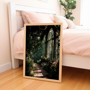 Printable wall art featuring a mystical greenhouse interior with deep green tones and vintage floral elements, perfect for a dark cottagecore or botanical witch aesthetic in any cozy living space. Ideal for instant download and home decor.