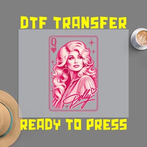 May include: A DTF transfer sheet featuring a pink graphic of a woman with voluminous hair styled as a playing card queen. The design includes the letter Q, a heart, star accents, and the script text Dolly. The text DTF TRANSFER READY TO PRESS appears.