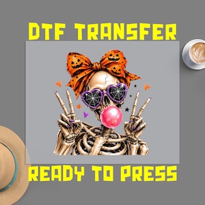 May include: A DTF transfer sheet featuring a skeleton graphic with an orange pumpkin-patterned bow, heart-shaped spiderweb sunglasses, and a pink bubblegum bubble. The skeleton makes peace signs with both hands, surrounded by small stars and hearts.