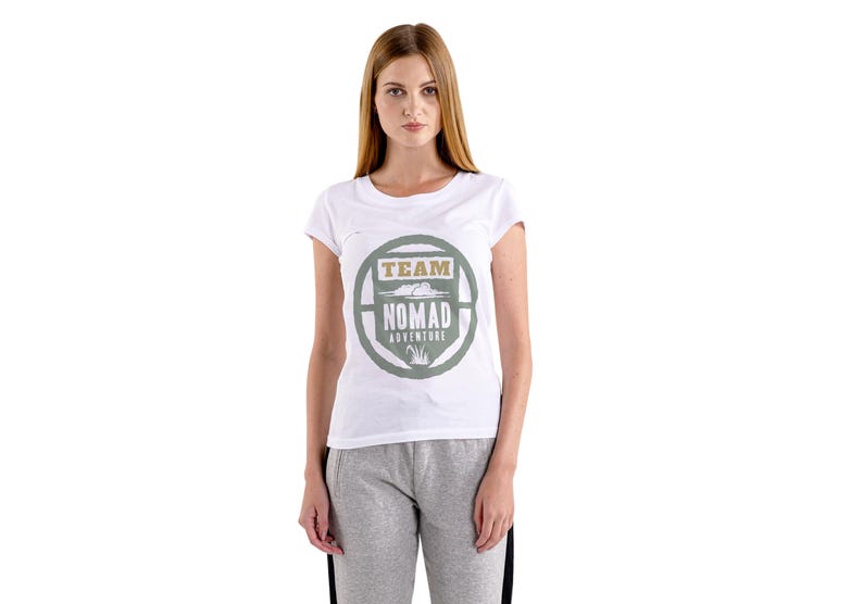 May include: White t-shirt with a crew neck and a circular graphic that reads "TEAM NOMAD ADVENTURE" in green and tan. The shirt is worn by a person wearing gray sweatpants.