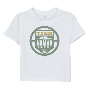 May include: White t-shirt with a crew neck and short sleeves. The front features a circular design with the words "TEAM NOMAD ADVENTURE" in a green and tan color scheme. The design includes cloud and grass graphics.